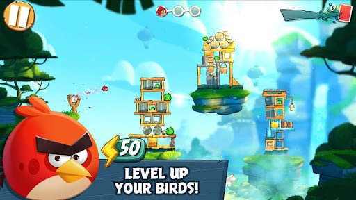 Angry Birds 2 colorful multi-stage level with wooden and ice structures housing sneaky green pigs