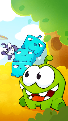Om Nom surrounded by colorful Nommie characters in a lush garden environment with candy dangling from ropes